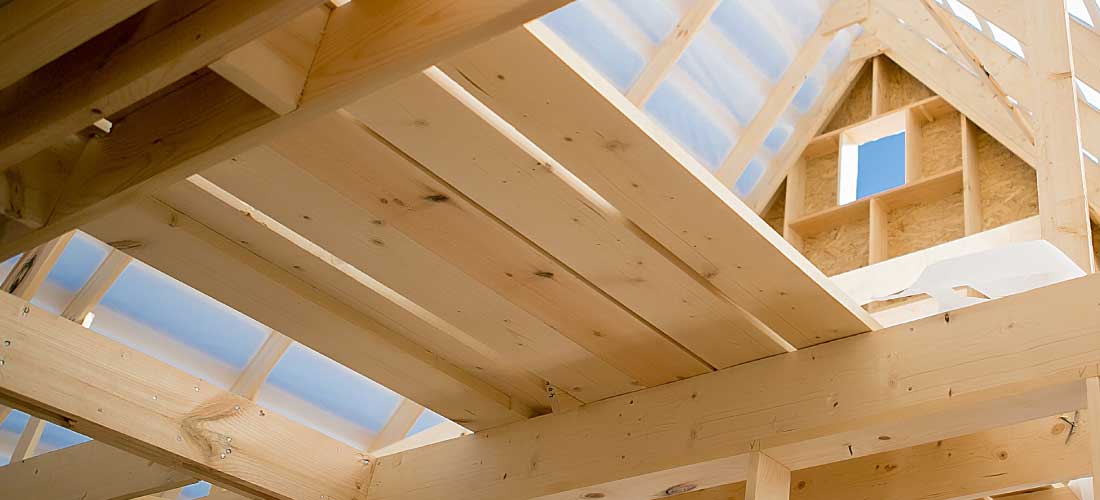 A construction site, looking up at rafters. Hempcrete, hemp boards, and hemp insulation are commonly used in green building projects like this.